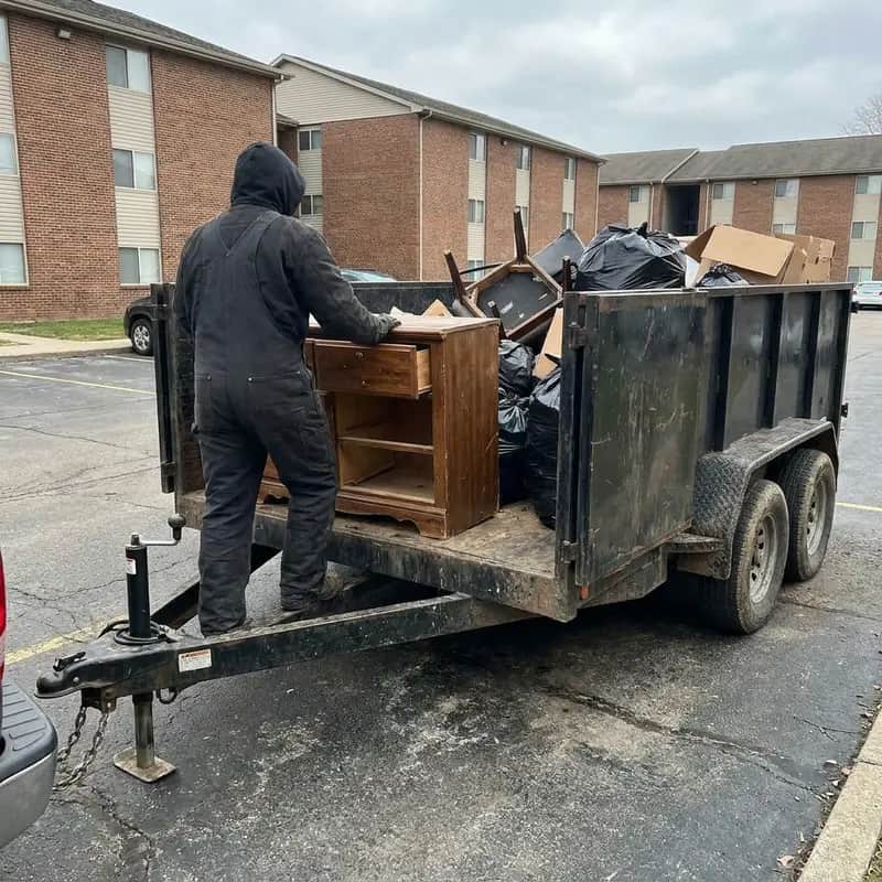 Furniture and trash being loaded for haul-away